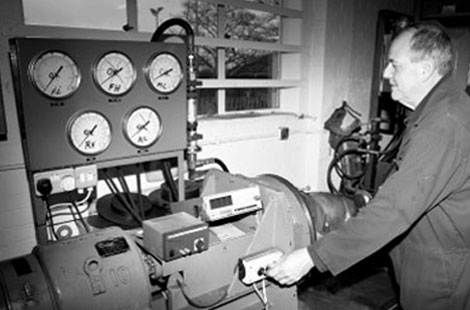 Man operating machinery with gauges